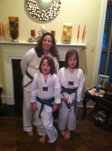 Tara Goodfellow with her two daughter (on the road to become black belts)
